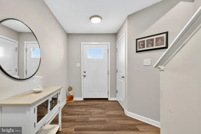 a view of an entryway with wooden floor