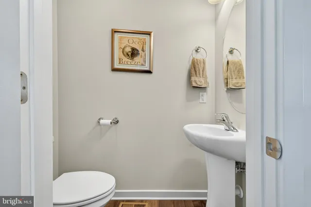 a bathroom with a sink mirror and toilet