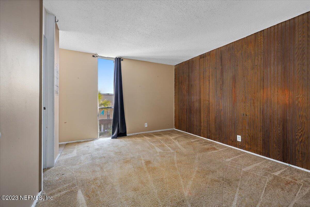 901 Ocean Boulevard, Unit 64 Atlantic Beach, FL 32233 - Photo 12 of 26 a view of an empty room with wooden walls