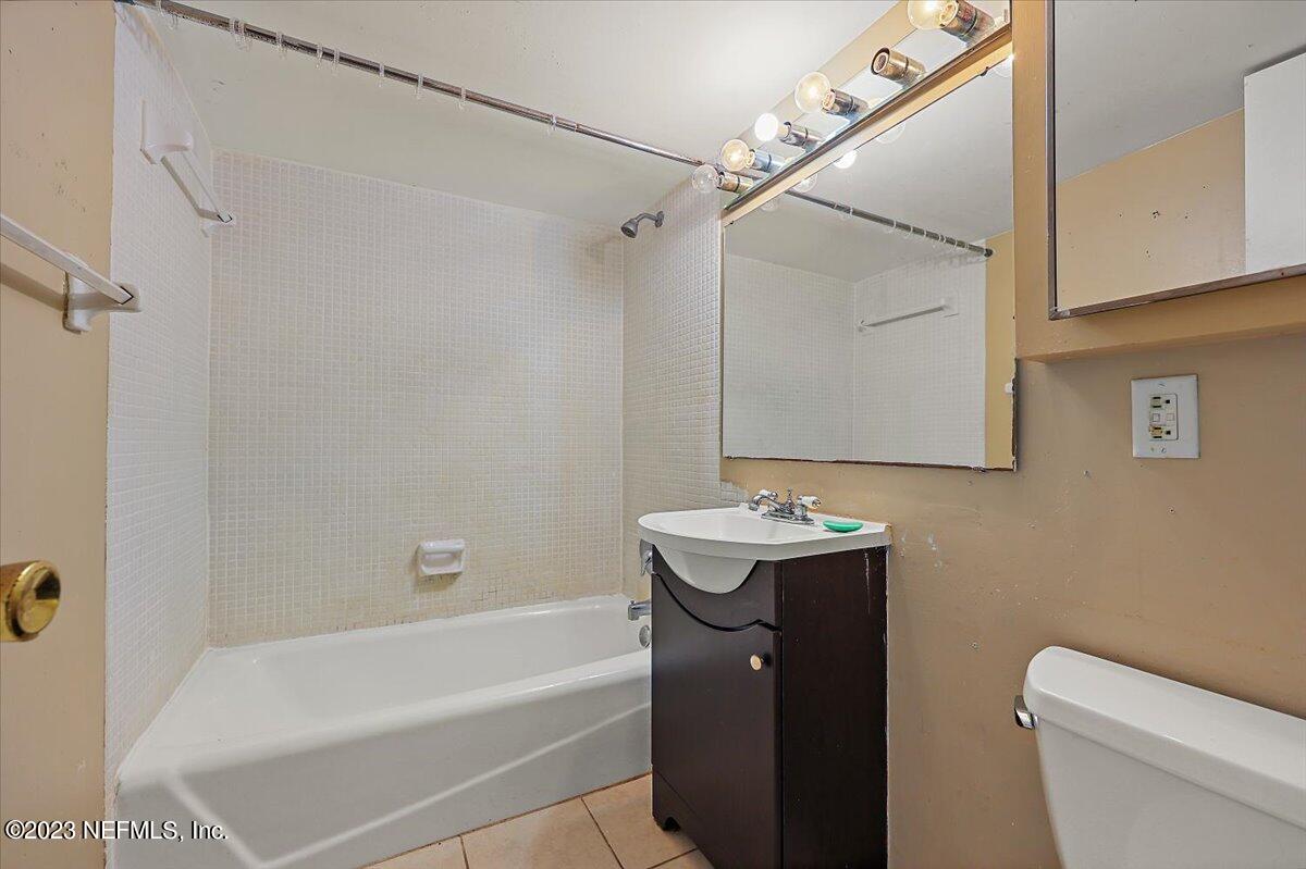 901 Ocean Boulevard, Unit 64 Atlantic Beach, FL 32233 - Photo 15 of 26 a bathroom with a sink a toilet and shower