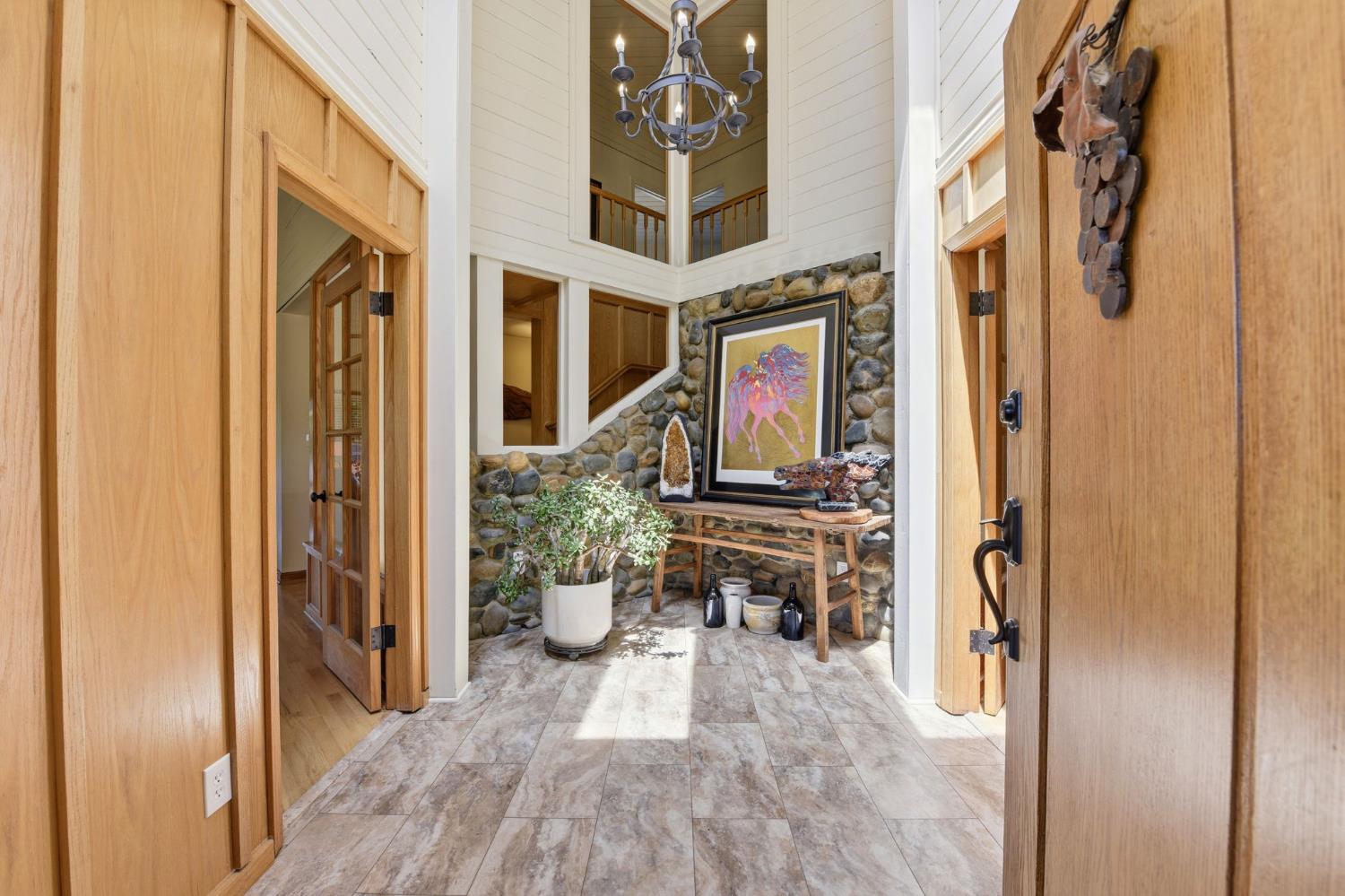 7201 Happy Valley Road Somerset, CA 95684 - Photo 10 of 75 The foyer is a peak inside the hub of the home that has river rock walls and makes for a lovely terrarium.