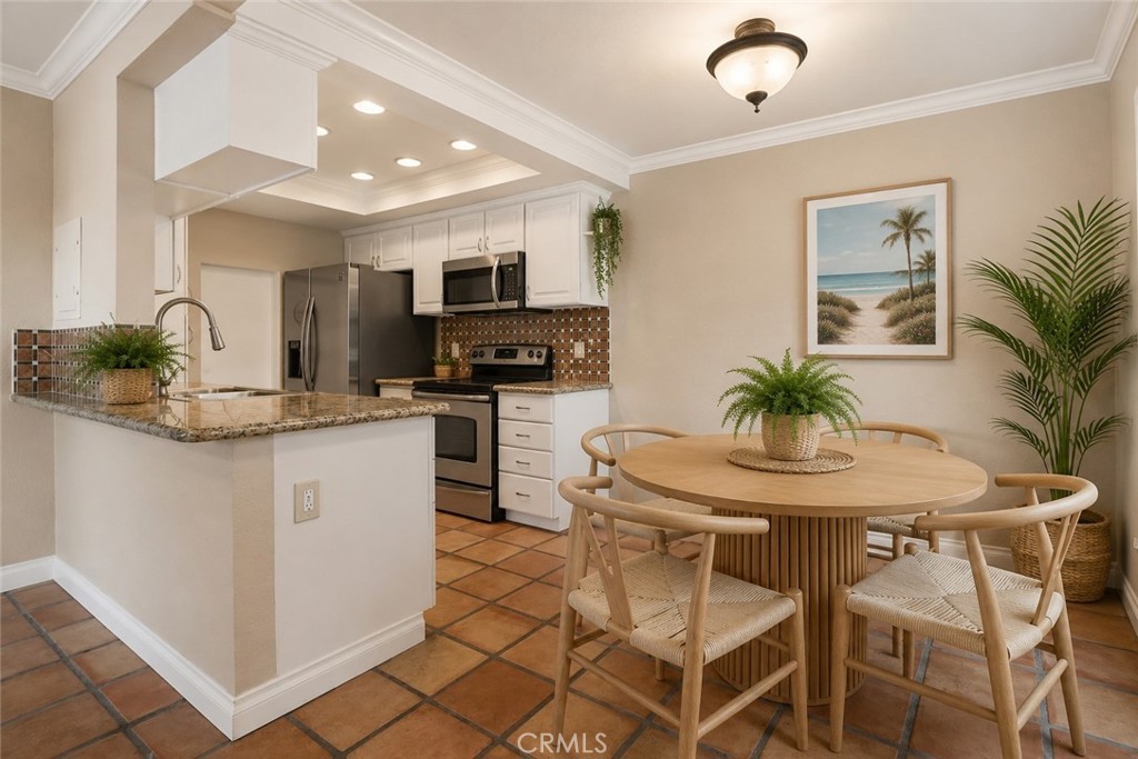 20702 El Toro Road, Unit 231 Lake Forest, CA 92630 - Photo 3 of 36 a kitchen with stainless steel appliances kitchen island granite countertop a sink and cabinets