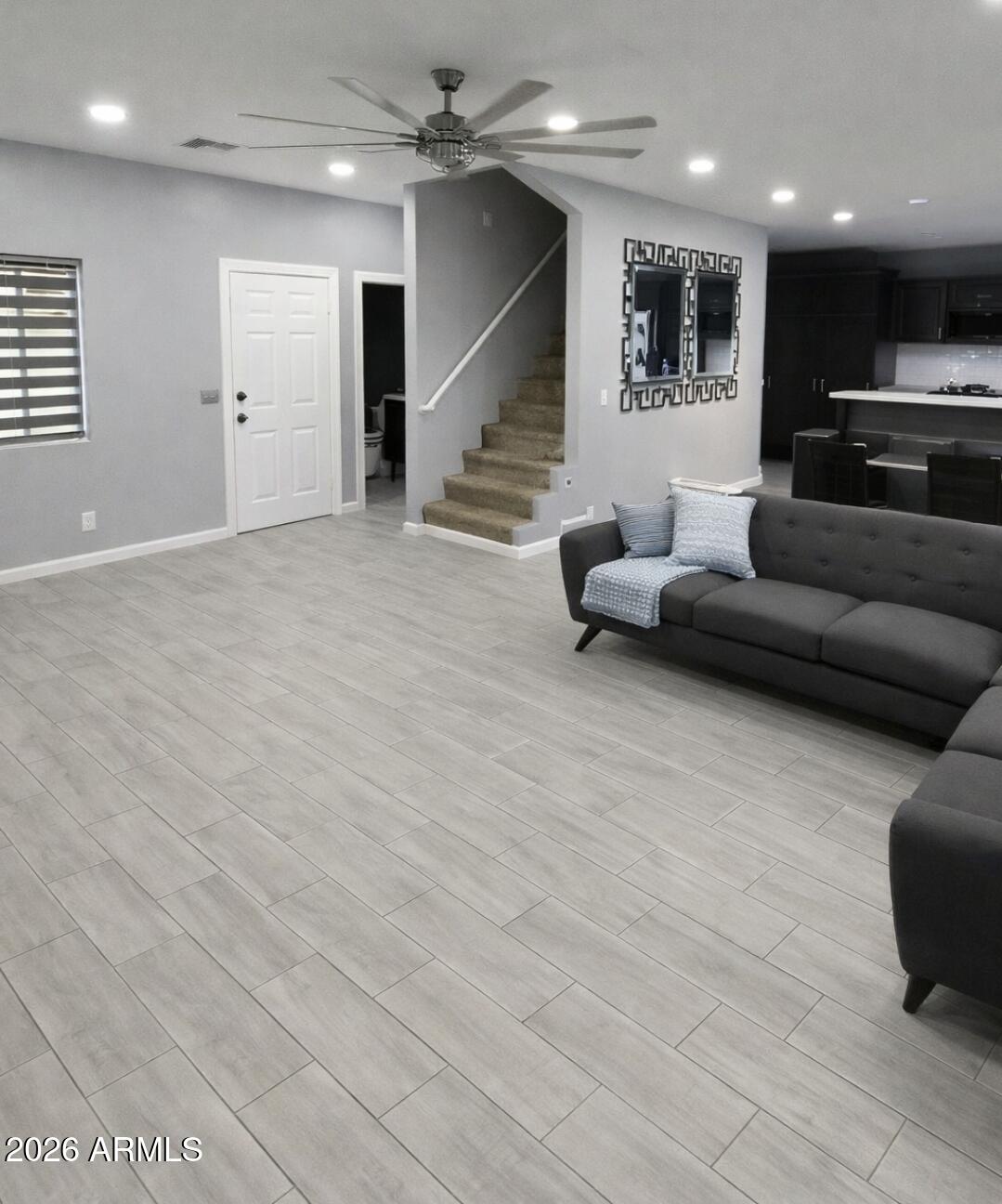 3202 South 66th Lane Phoenix, AZ 85043 - Photo 2 of 2 a living room with furniture and a ceiling fan