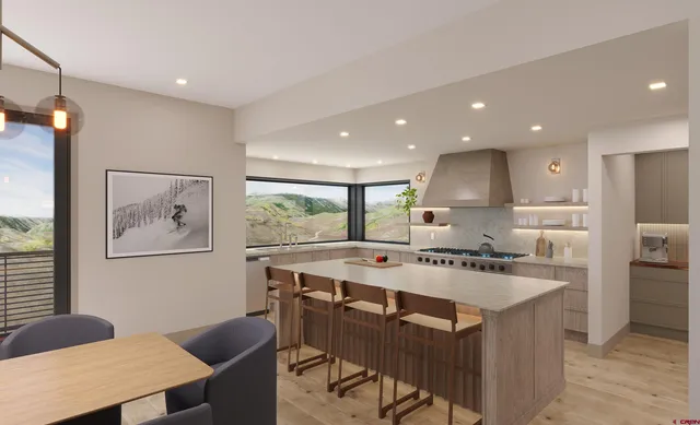 a kitchen with a counter top space appliances and a chandelier