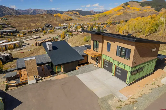 an aerial view of a house with a yard