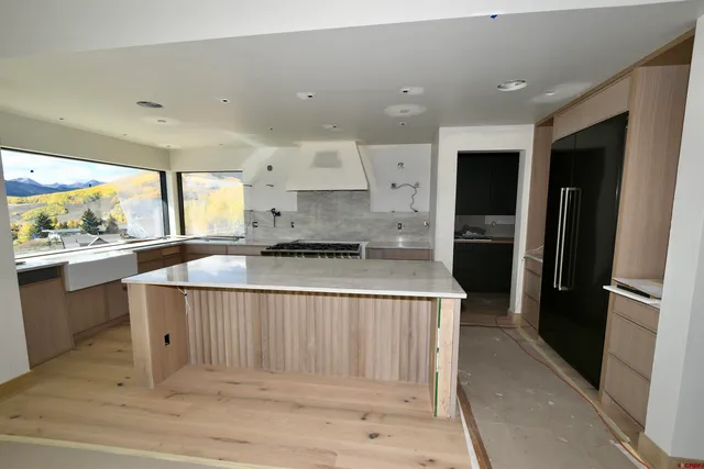 a view of a hallway with couches and dining table