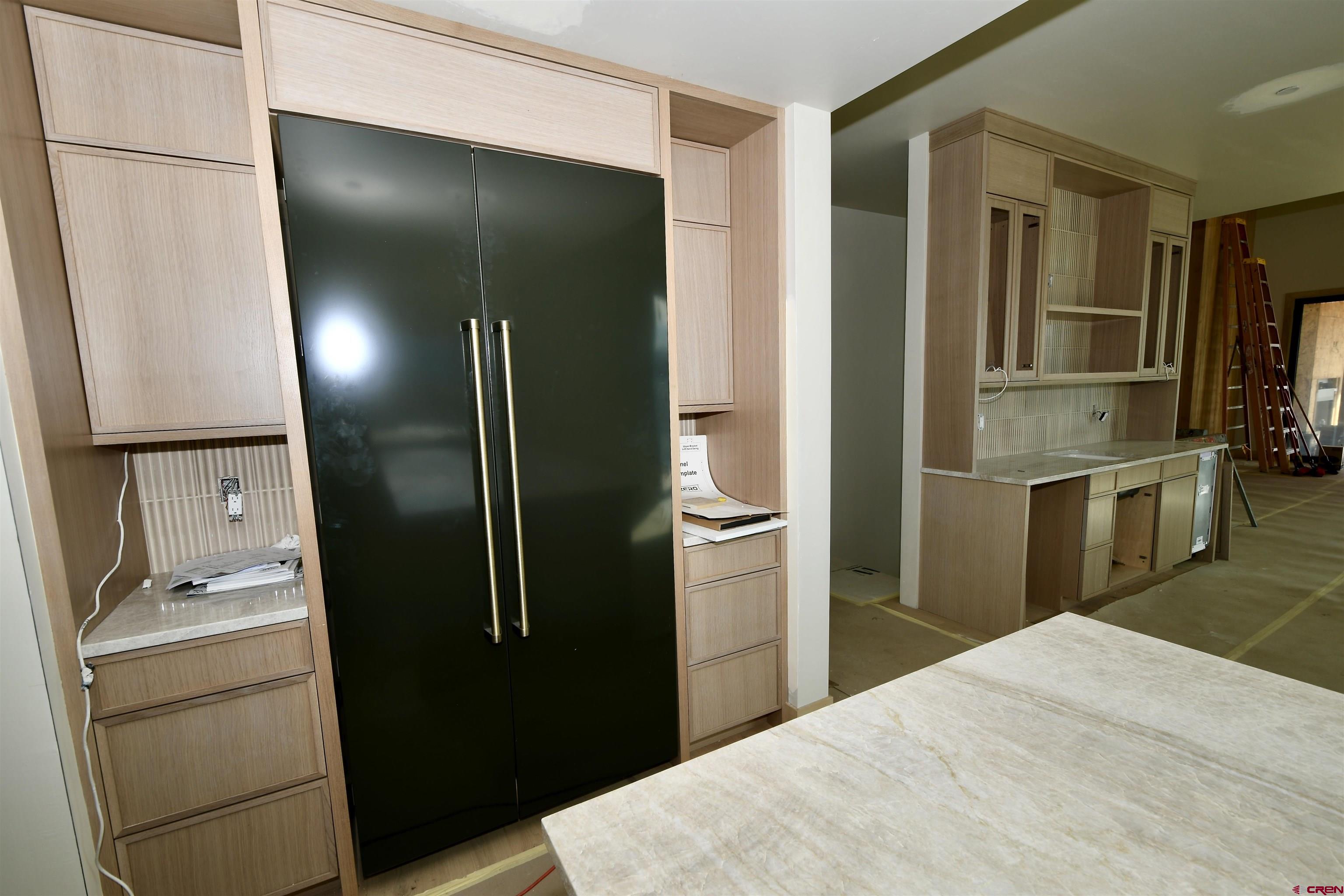 63 Cinnamon Mountain Road Crested Butte, CO 81225 - Photo 30 of 45 a kitchen with stainless steel appliances kitchen island a refrigerator and microwave
