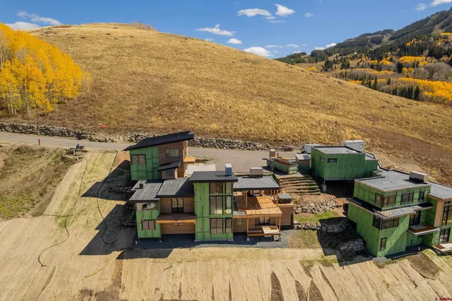 an aerial view of residential houses with outdoor space