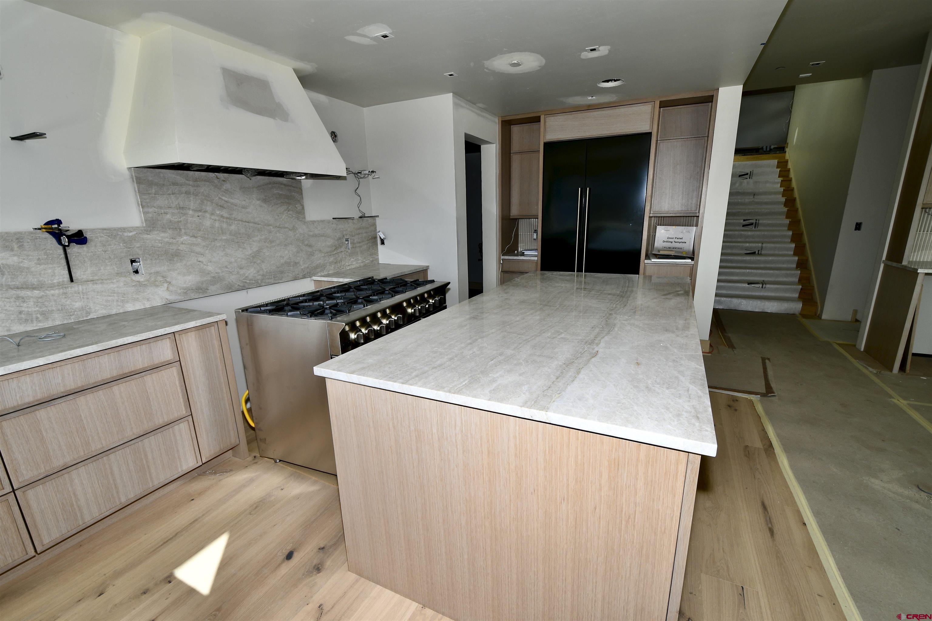 63 Cinnamon Mountain Road Crested Butte, CO 81225 - Photo 32 of 45 a kitchen with a sink a stove and cabinets