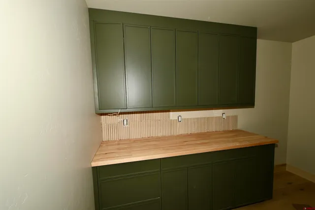 a bathroom with a granite countertop sink and mirror