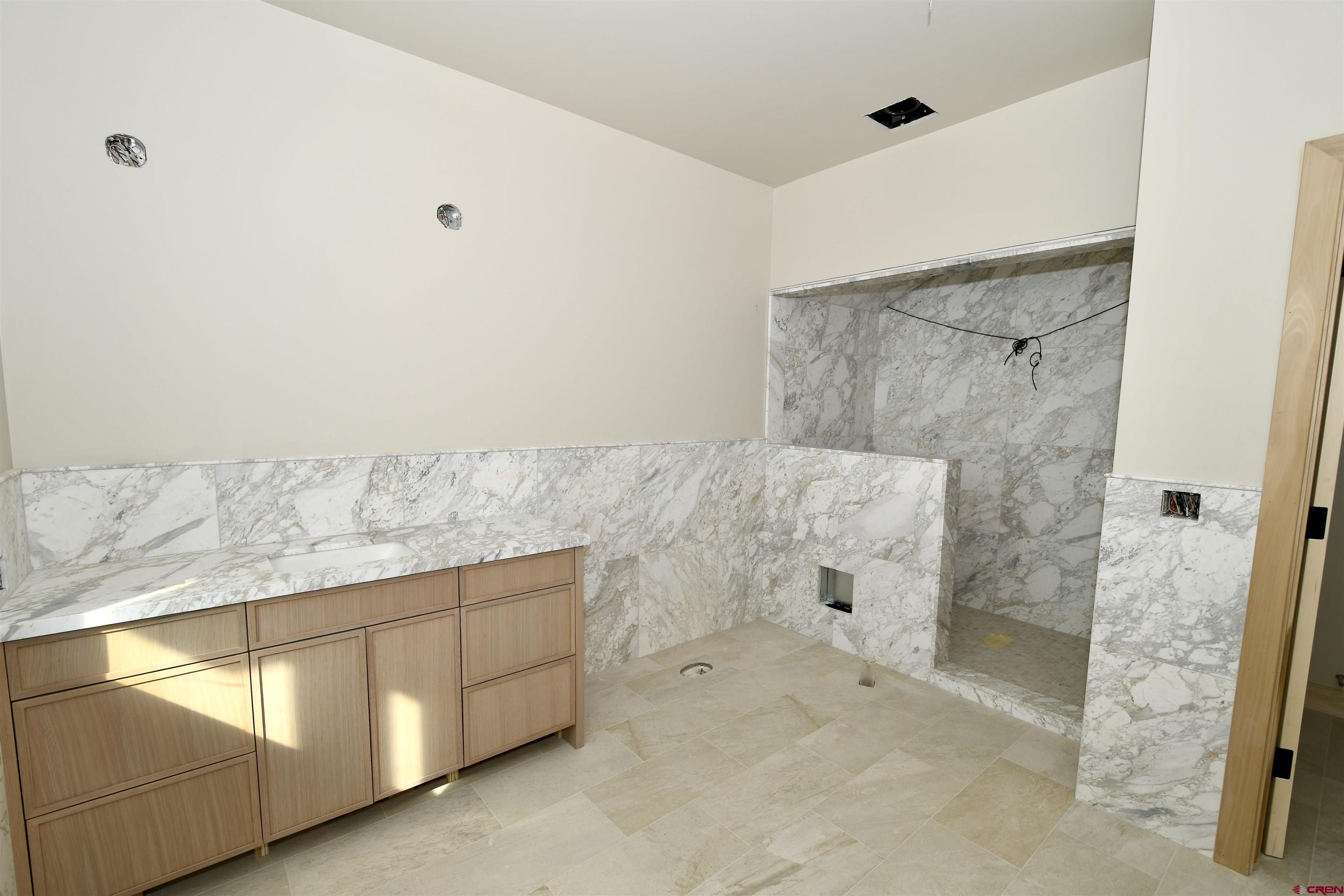 63 Cinnamon Mountain Road Crested Butte, CO 81225 - Photo 37 of 45 a bathroom with a bathtub and shower