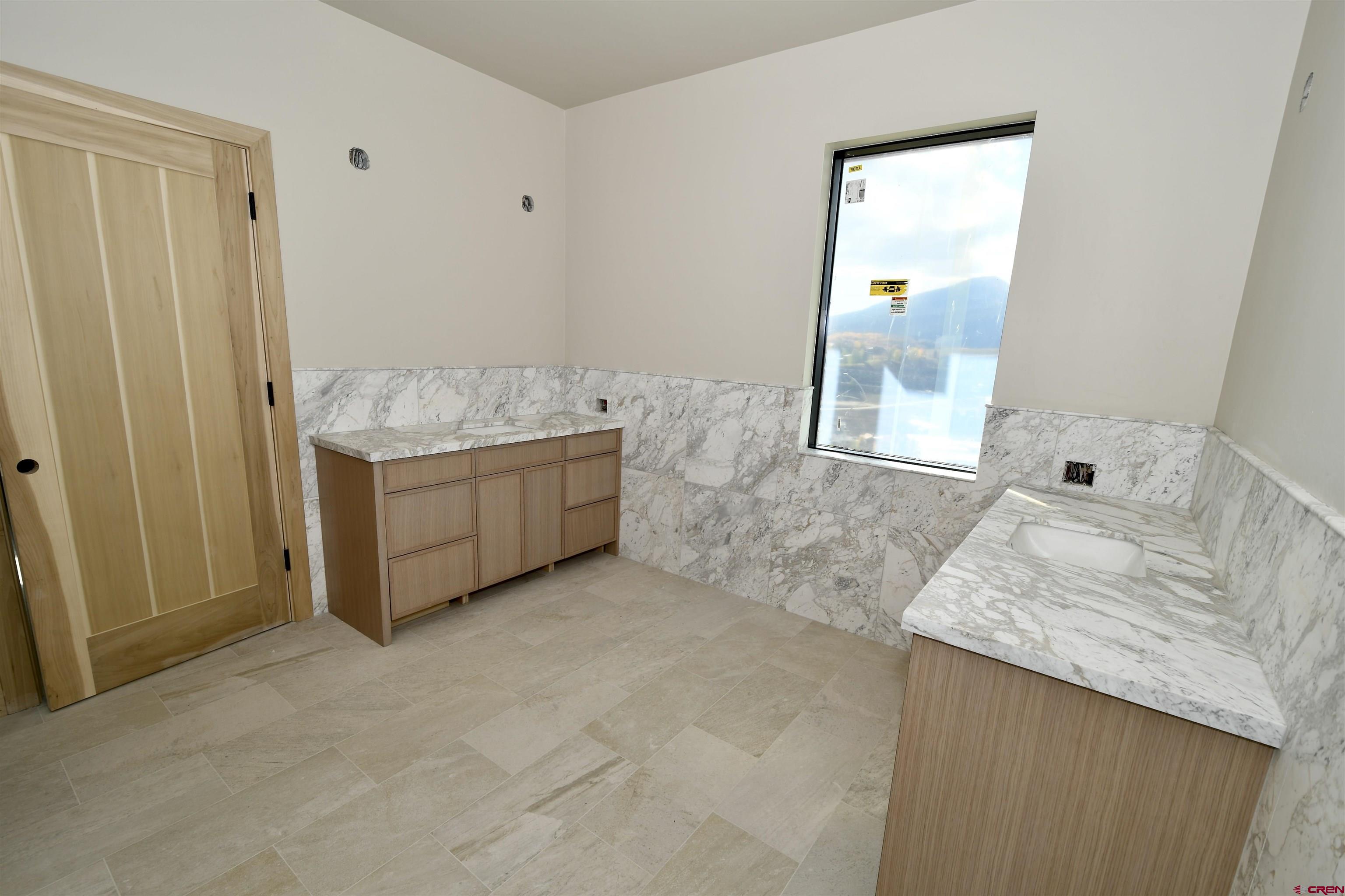 63 Cinnamon Mountain Road Crested Butte, CO 81225 - Photo 38 of 45 a bathroom with a granite countertop sink and mirror