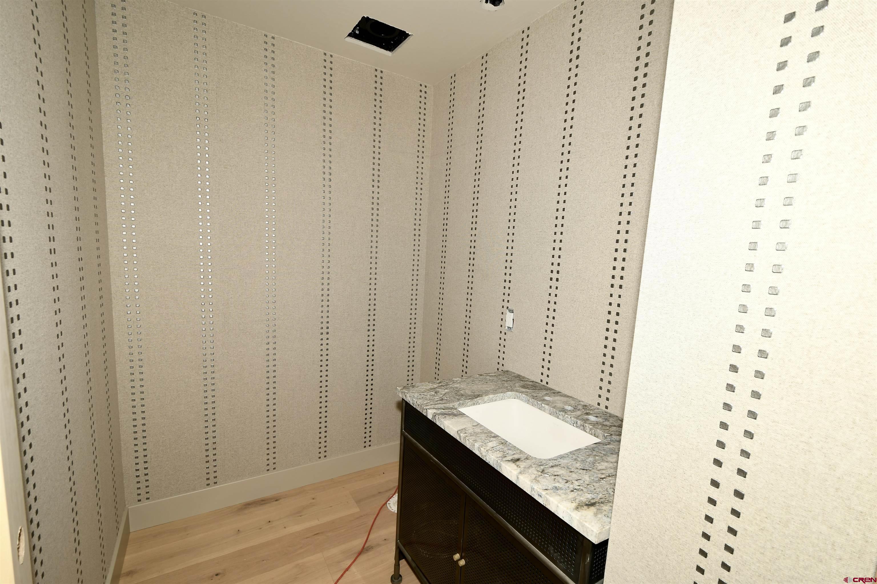 63 Cinnamon Mountain Road Crested Butte, CO 81225 - Photo 39 of 45 a bathroom with a granite countertop sink and a mirror
