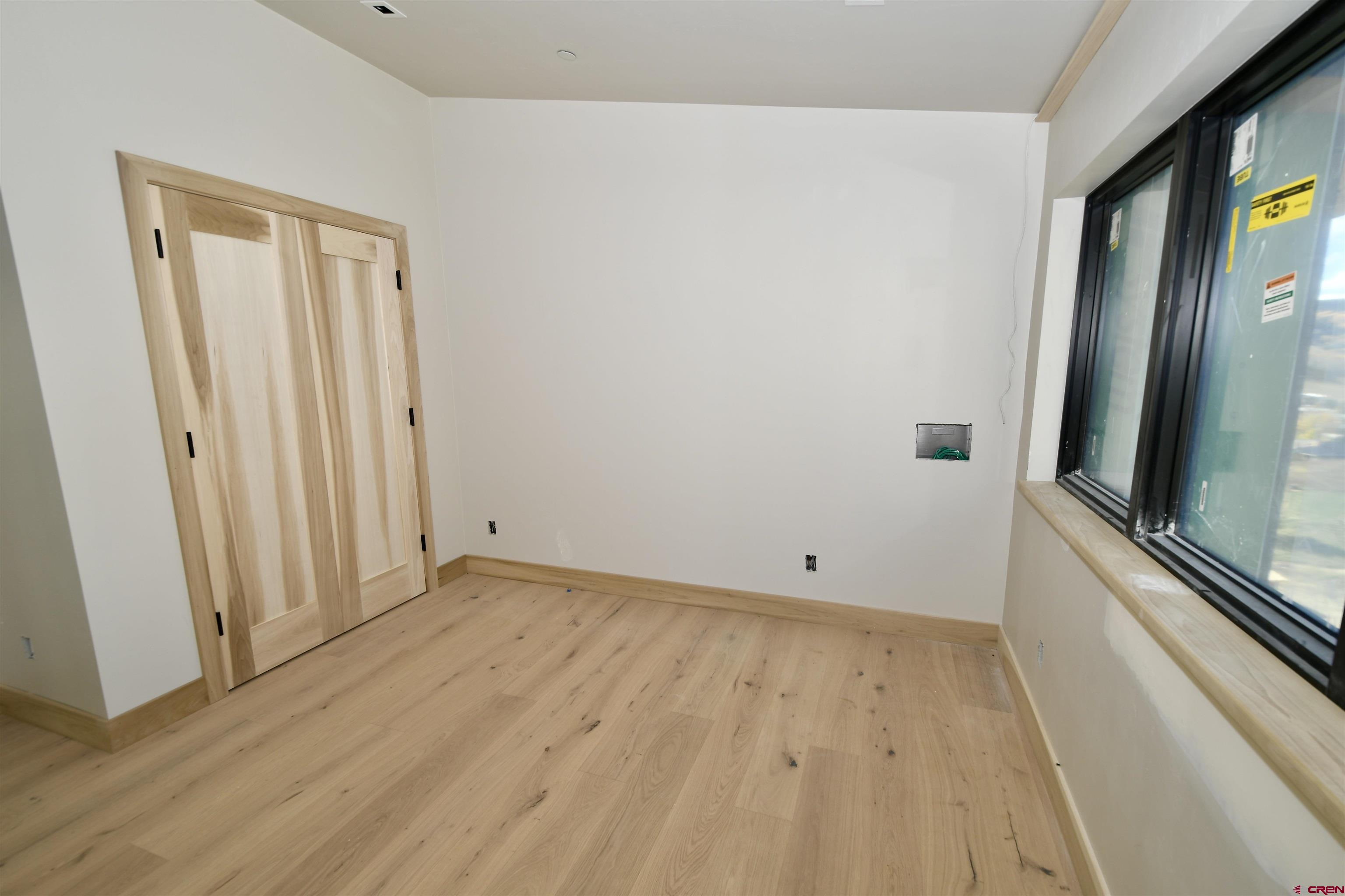 63 Cinnamon Mountain Road Crested Butte, CO 81225 - Photo 41 of 45 a view of empty room with wooden floor and fan