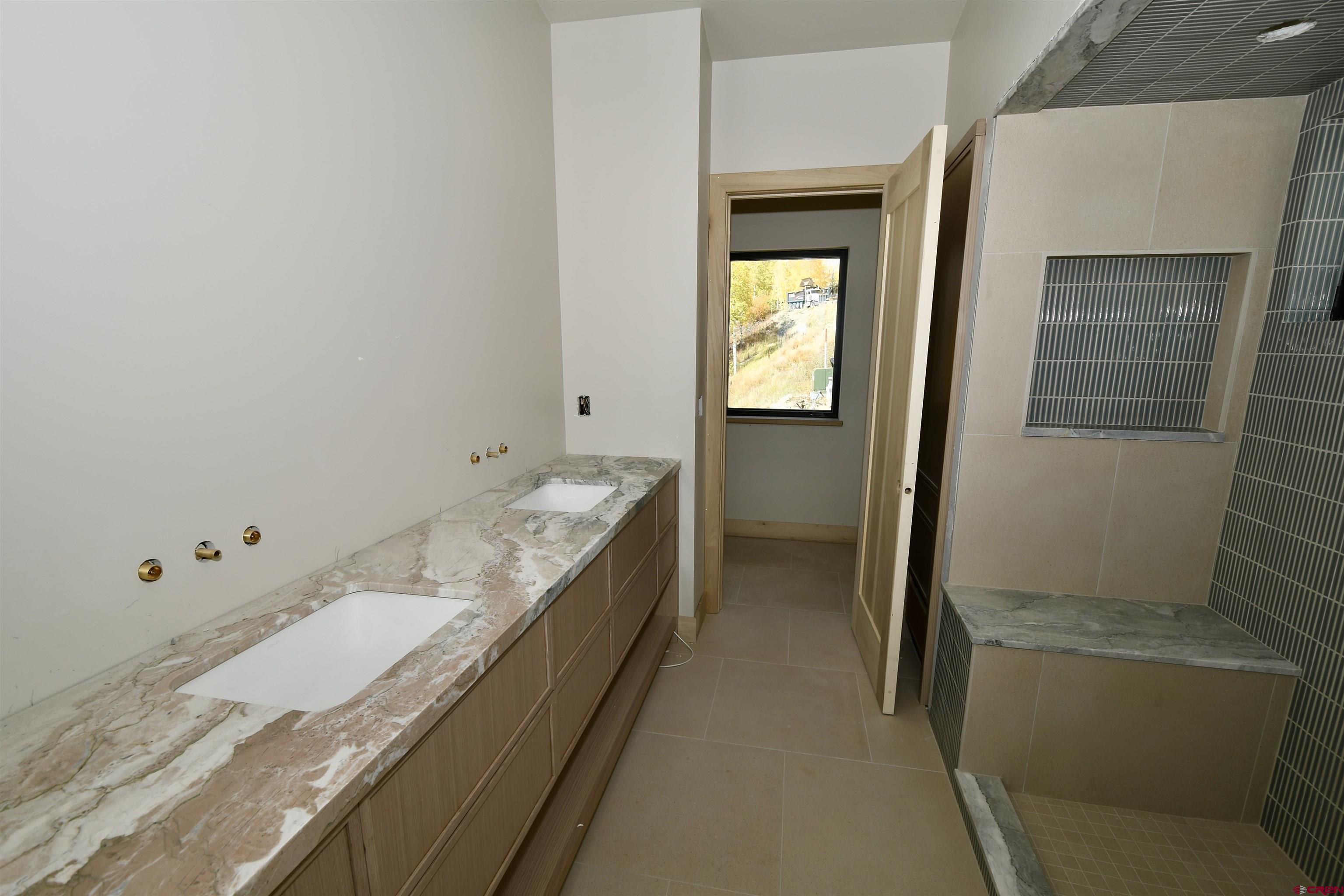 63 Cinnamon Mountain Road Crested Butte, CO 81225 - Photo 42 of 45 a bathroom with a bathtub and a sink
