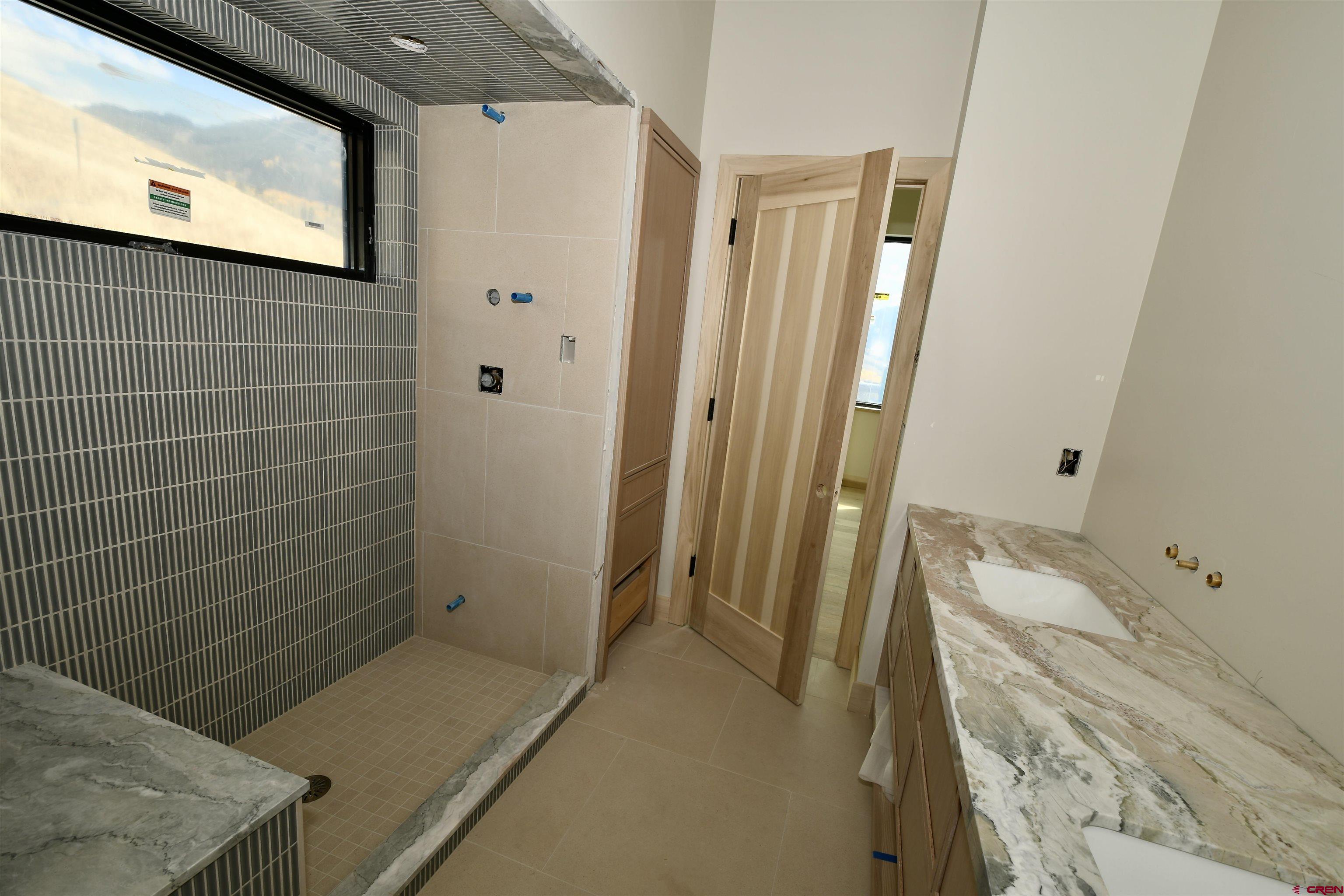 63 Cinnamon Mountain Road Crested Butte, CO 81225 - Photo 43 of 45 a bathroom with a sink a toilet and a shower