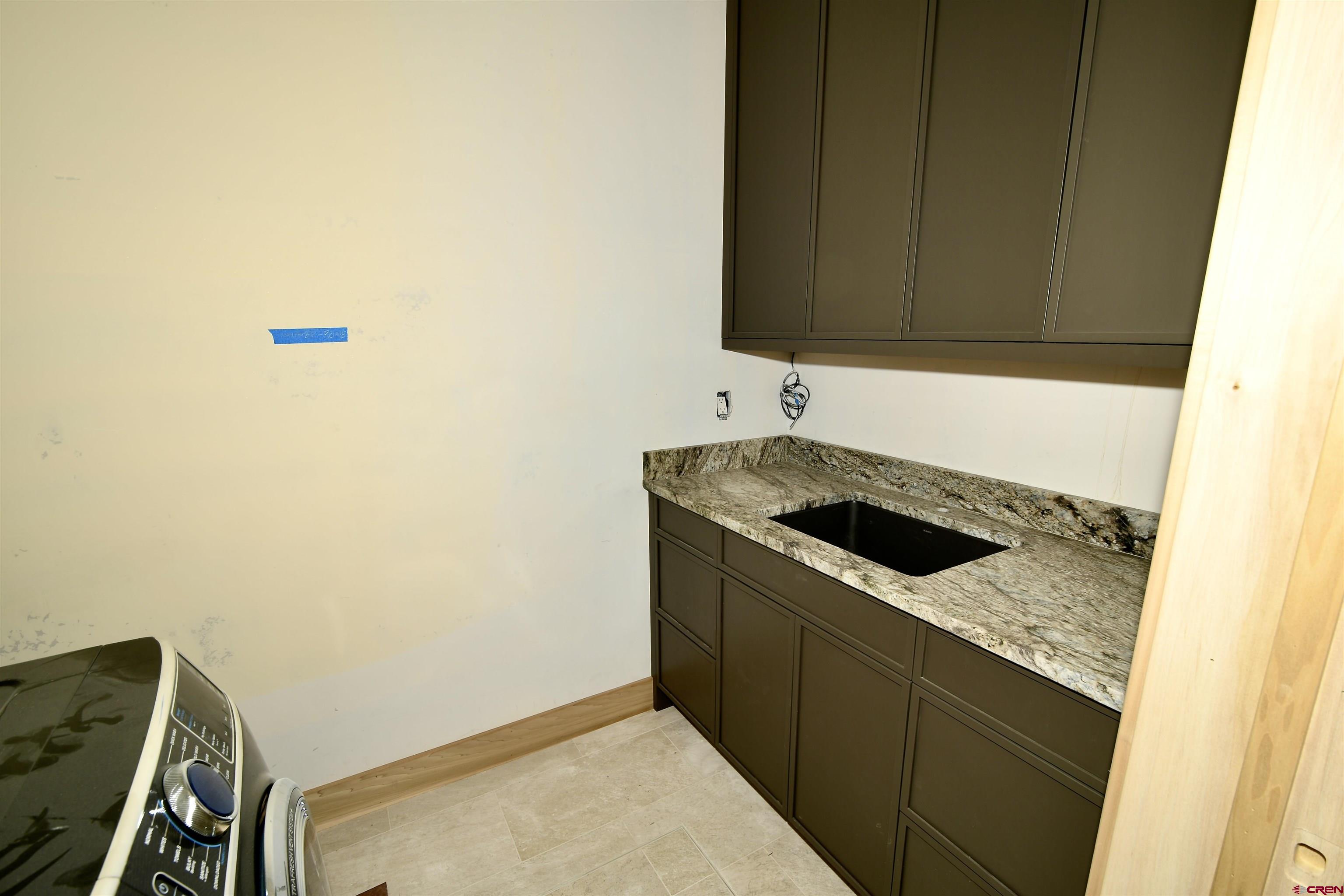 63 Cinnamon Mountain Road Crested Butte, CO 81225 - Photo 44 of 45 a kitchen with a sink and a stove top oven