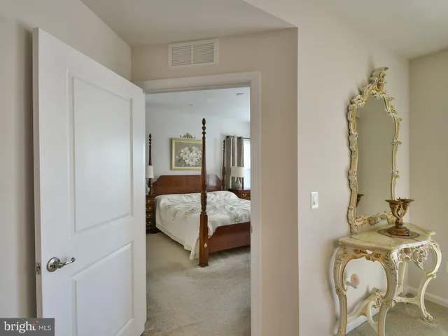 a bedroom with a bed and a mirror