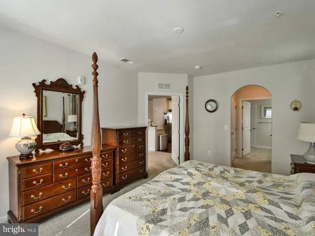 a bedroom with a bed and a dresser in it