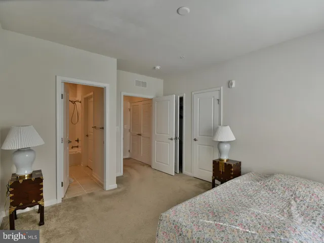 a bathroom with a granite countertop toilet sink and mirror