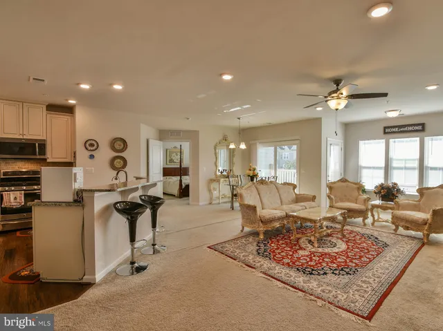 a living room with furniture a rug and a chandelier