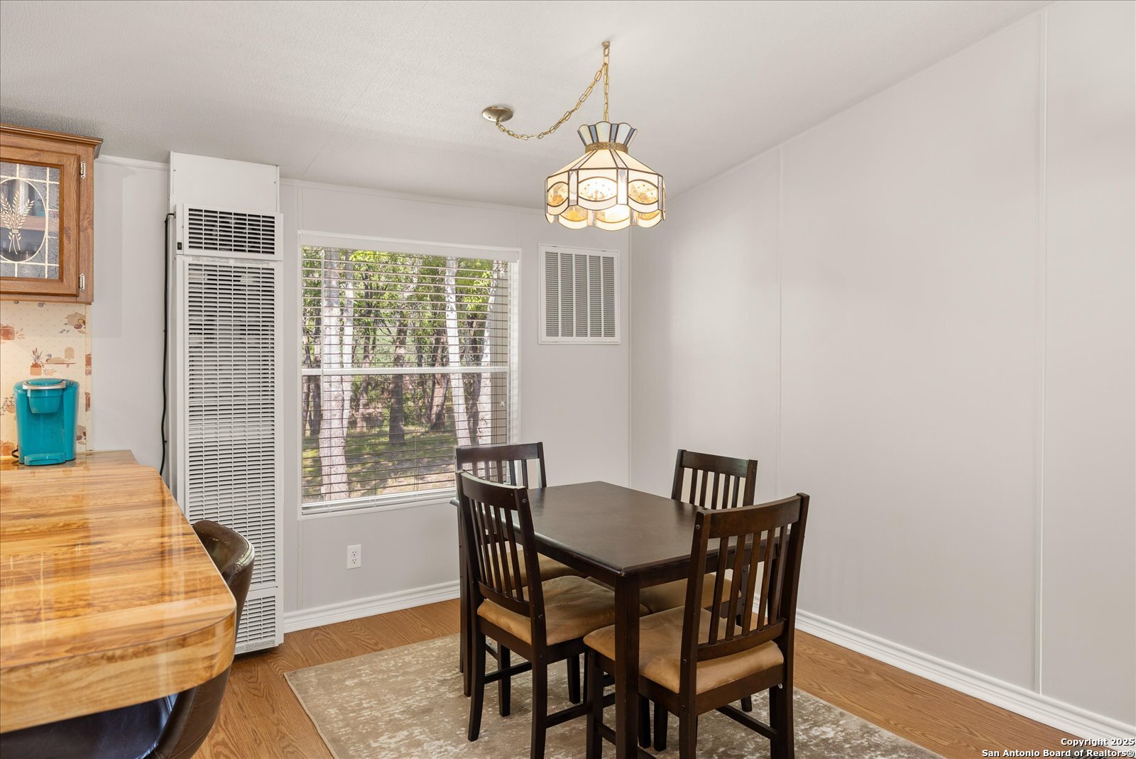 363 Elm Pass II Road East Center Point, TX 78010 - Photo 15 of 50 a view of a dining room with furniture window and wooden floor