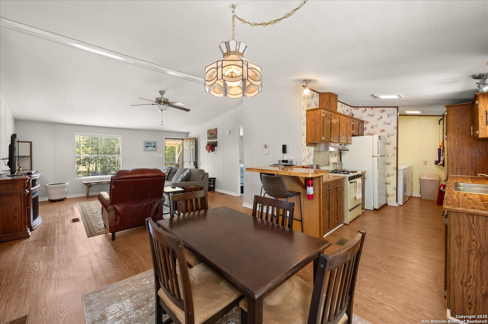 363 Elm Pass II Road East Center Point, TX 78010 - Photo 16 of 50 a view of a dining room with furniture window and wooden floor