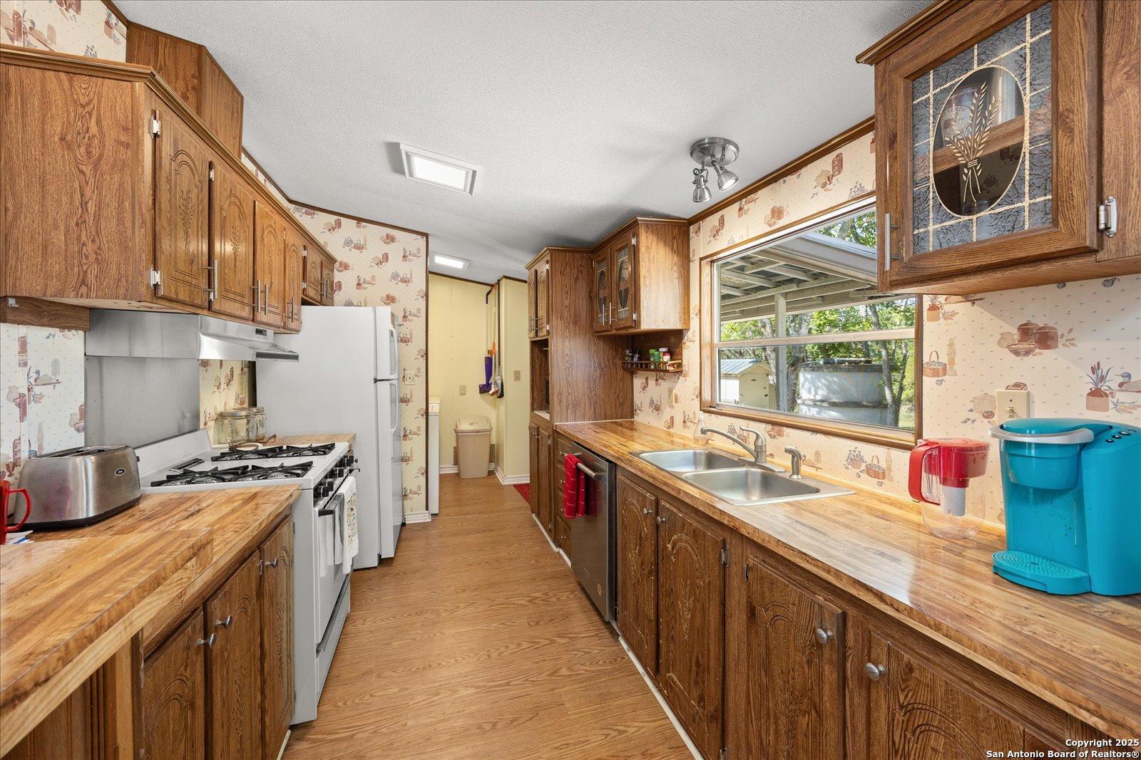 363 Elm Pass II Road East Center Point, TX 78010 - Photo 18 of 50 a kitchen with stainless steel appliances granite countertop a sink and a stove