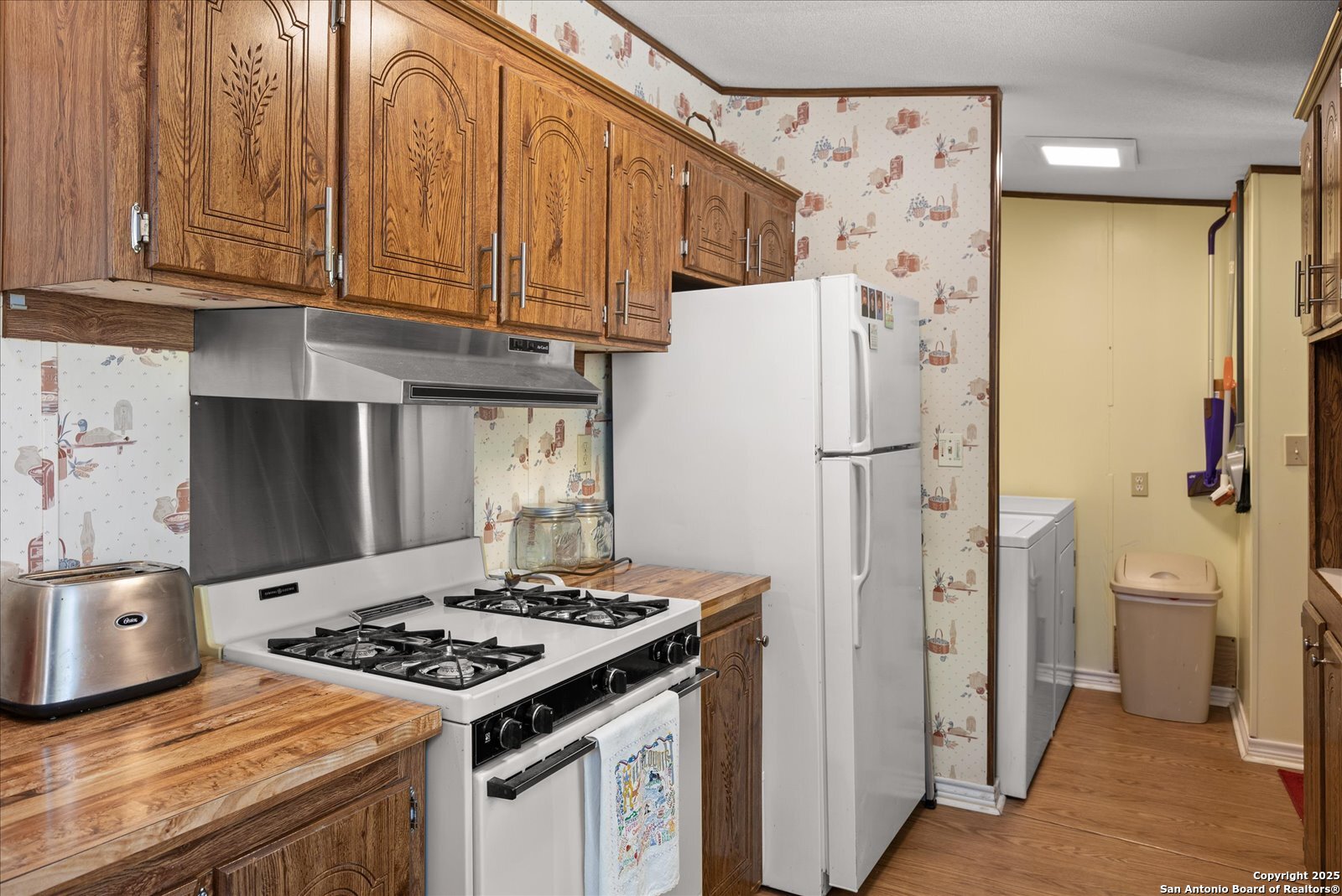 363 Elm Pass II Road East Center Point, TX 78010 - Photo 19 of 50 a kitchen with stainless steel appliances granite countertop a refrigerator stove and cabinets