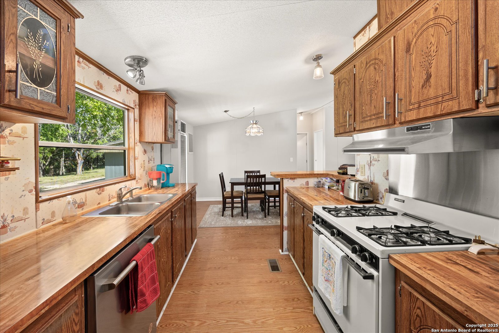 363 Elm Pass II Road East Center Point, TX 78010 - Photo 21 of 50 a kitchen with kitchen island a sink stove and cabinets