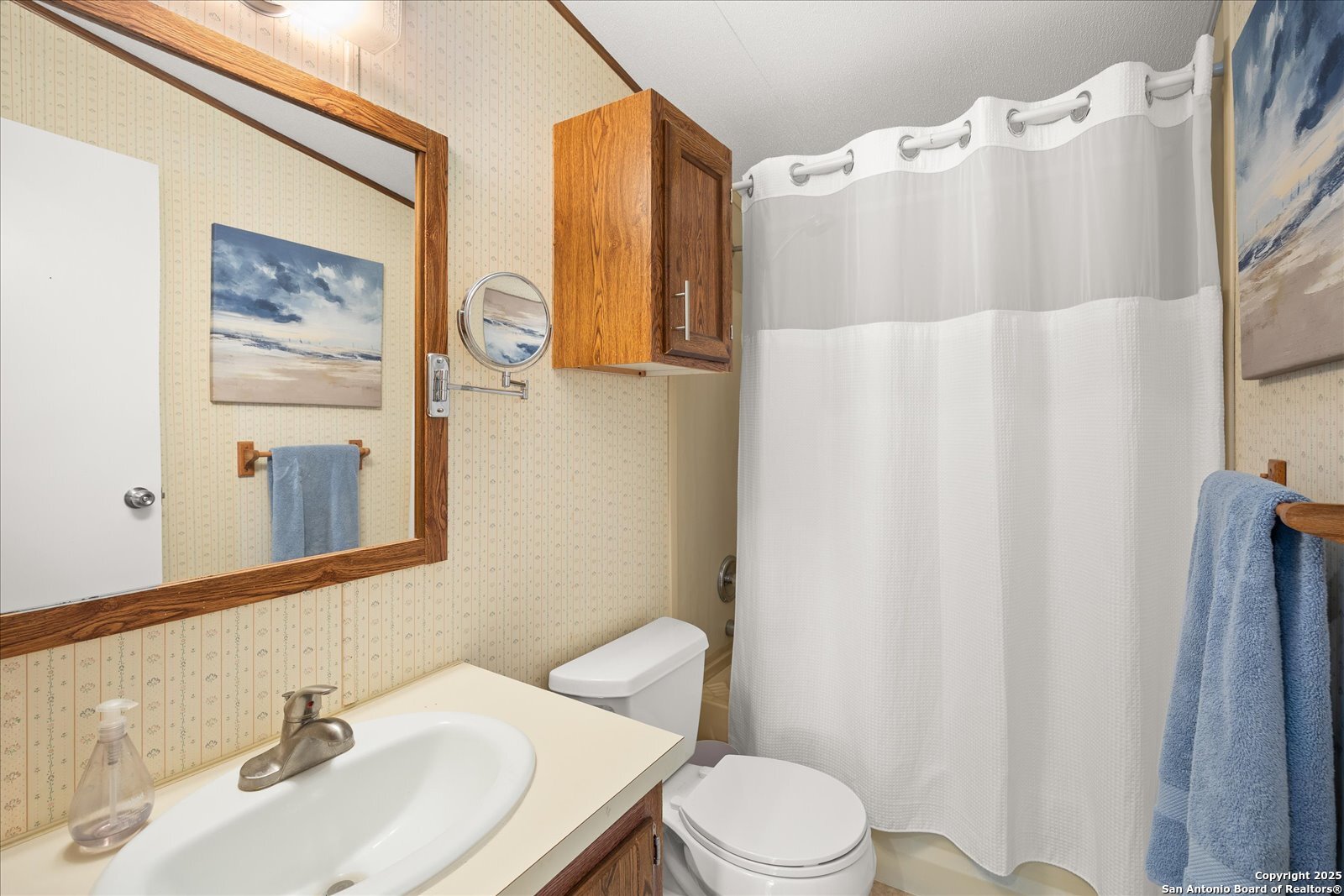 363 Elm Pass II Road East Center Point, TX 78010 - Photo 26 of 50 a white toilet sitting next to a bathroom sink