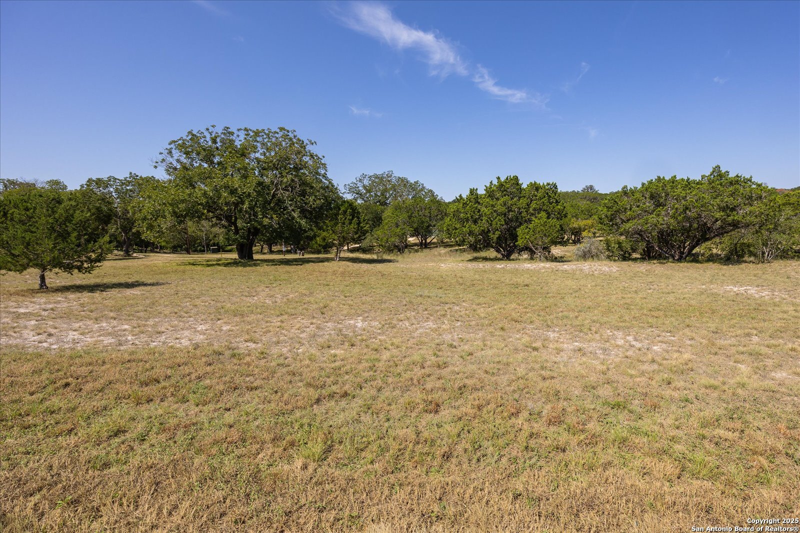 363 Elm Pass II Road East Center Point, TX 78010 - Photo 3 of 50 a backyard of a house with a yard and mountain view in back