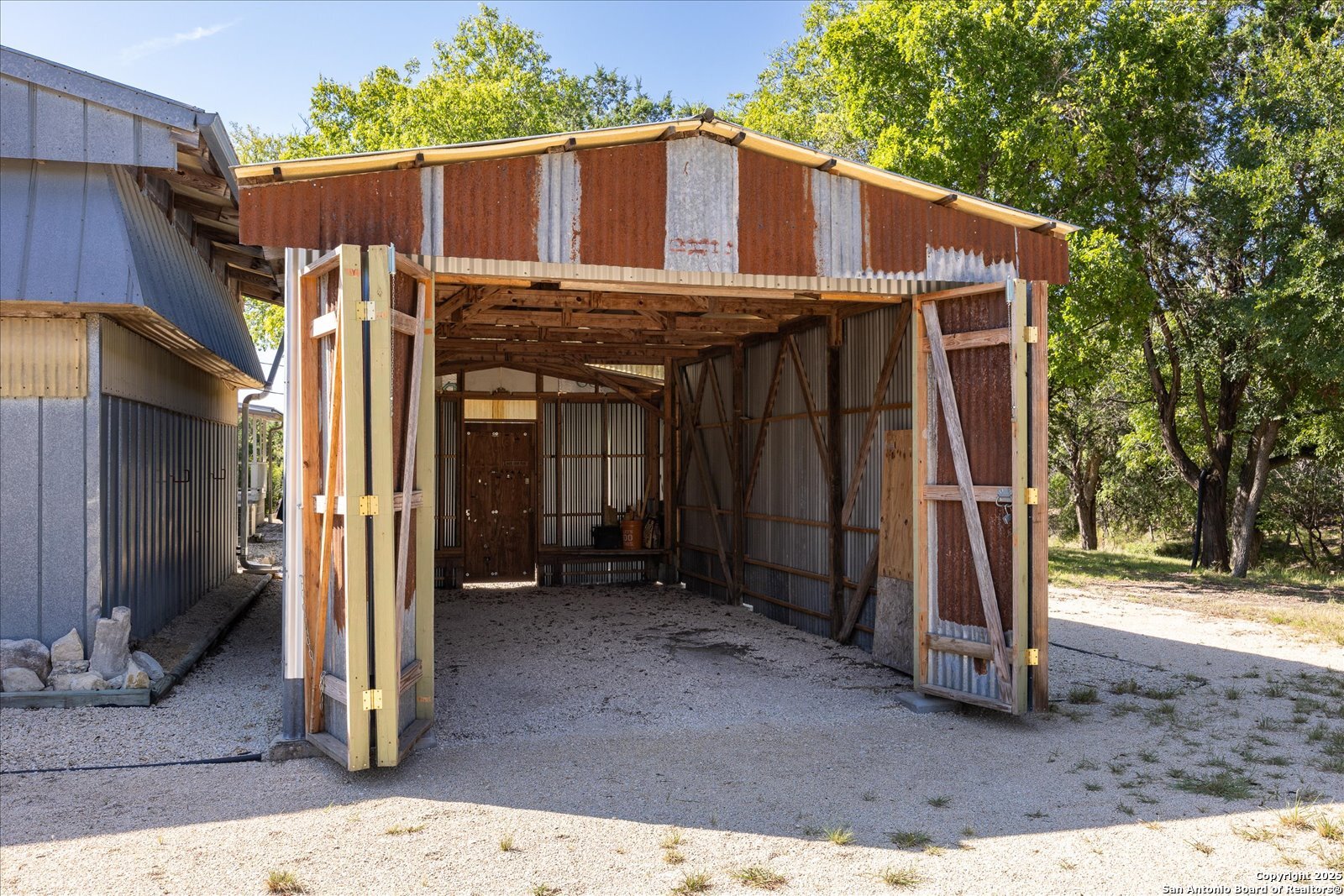 363 Elm Pass II Road East Center Point, TX 78010 - Photo 40 of 50 a view of a wooden house with a large tree and wooden fence