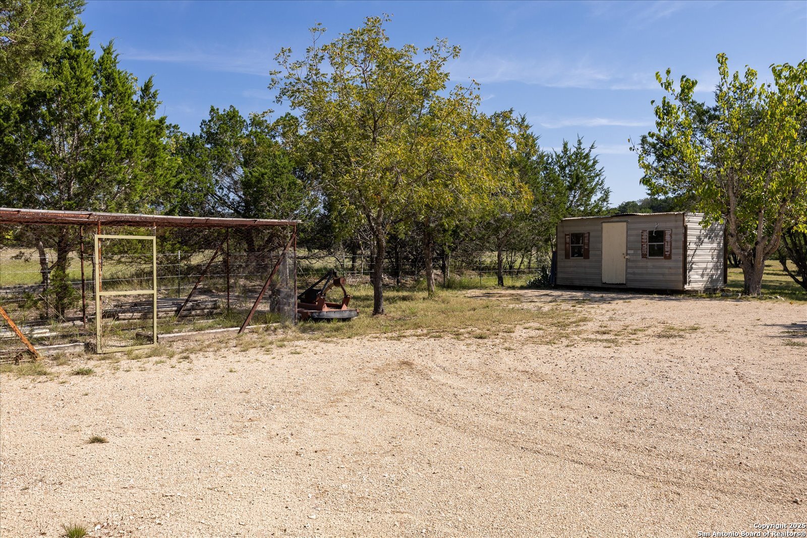 363 Elm Pass II Road East Center Point, TX 78010 - Photo 41 of 50 a house with trees in the background