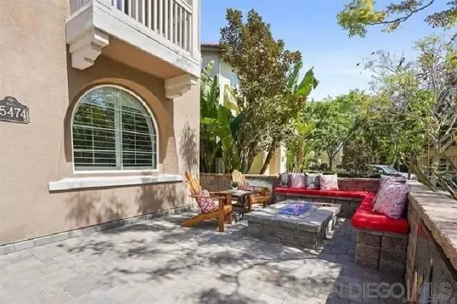 a backyard of a house with outdoor seating