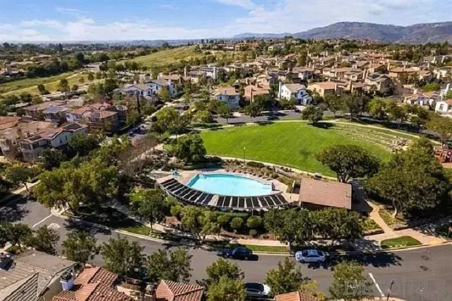 an aerial view of a house with a garden and lake view