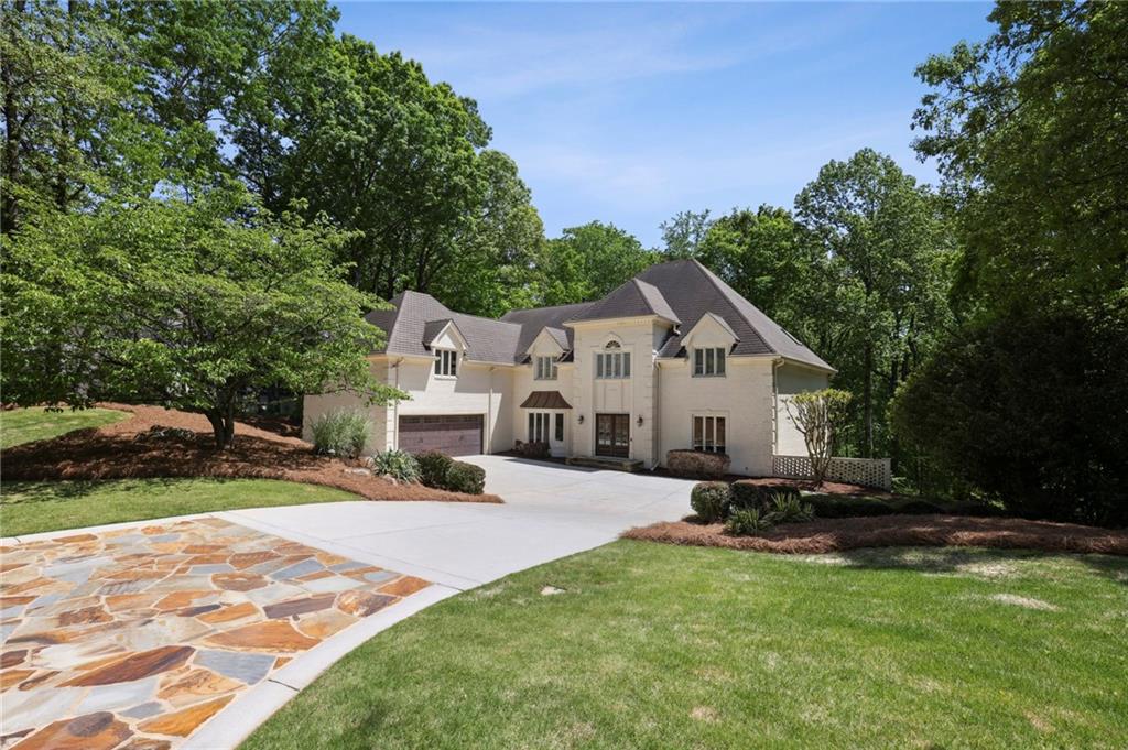 a house view with a sitting space and garden