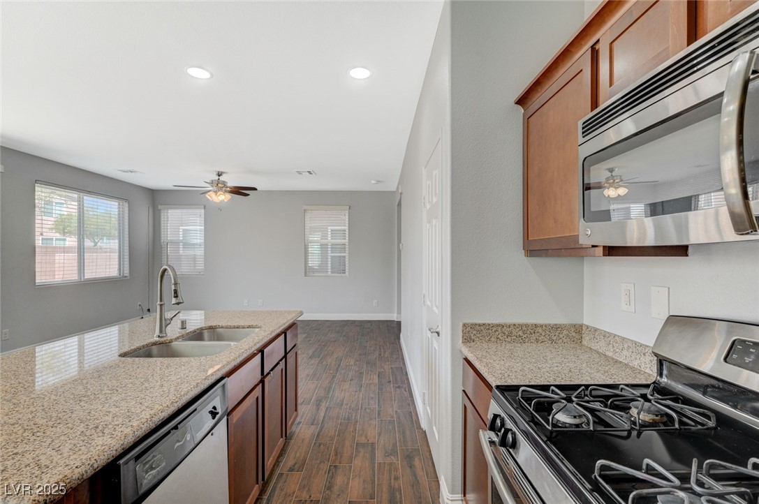 5377 Panaca Spring Street Las Vegas, NV 89122 - Photo 21 of 59 Kitchen featuring appliances with stainless steel finishes, ceiling fan, light stone counters, and recessed lighting