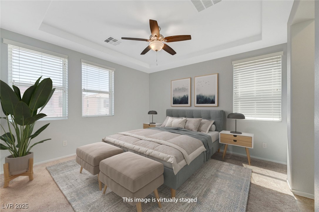 5377 Panaca Spring Street Las Vegas, NV 89122 - Photo 26 of 59 Bedroom featuring a raised ceiling, carpet, and ceiling fan
