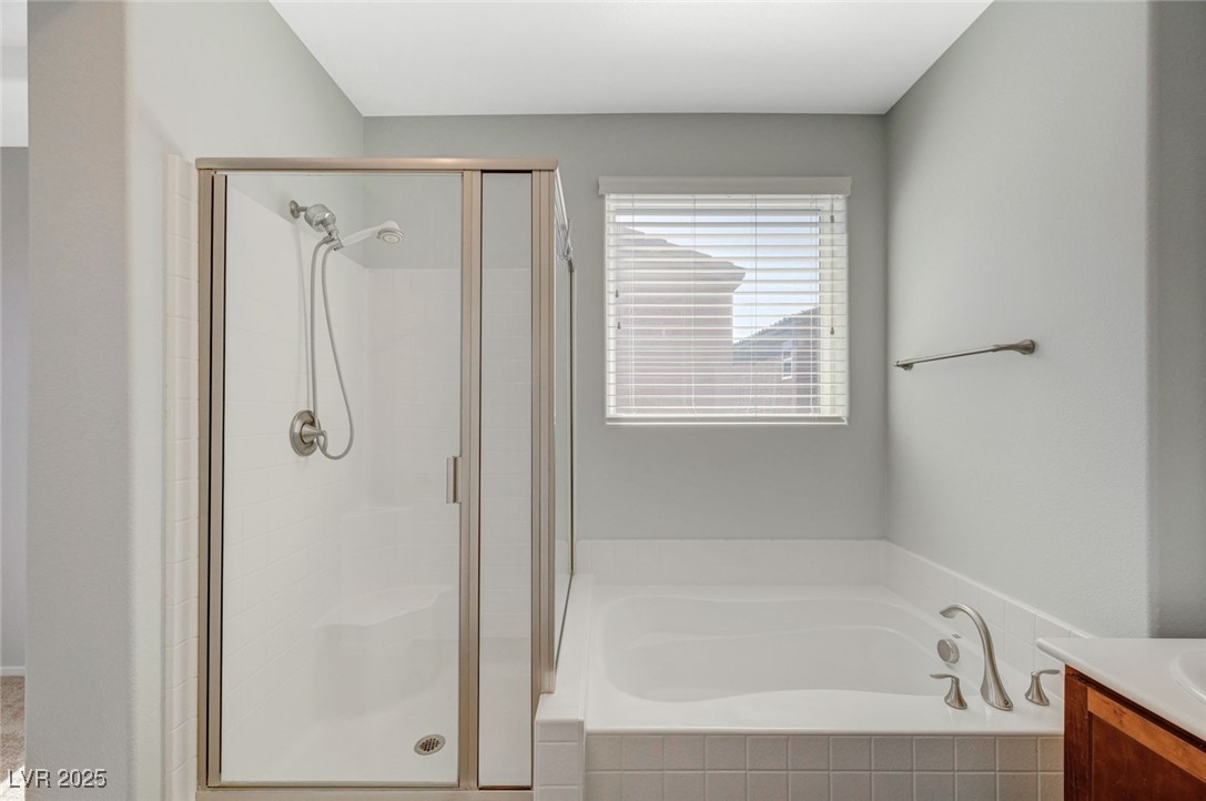 5377 Panaca Spring Street Las Vegas, NV 89122 - Photo 32 of 59 Bathroom featuring vanity, a stall shower, and a garden tub