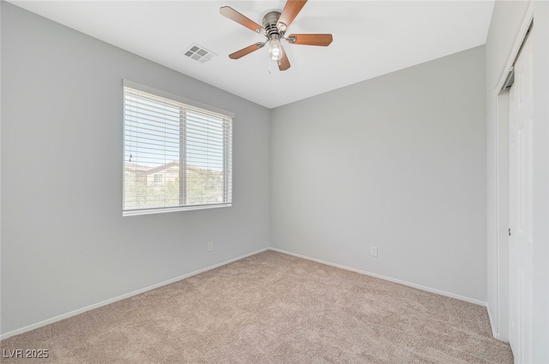 5377 Panaca Spring Street Las Vegas, NV 89122 - Photo 35 of 59 Spare room with light colored carpet and ceiling fan