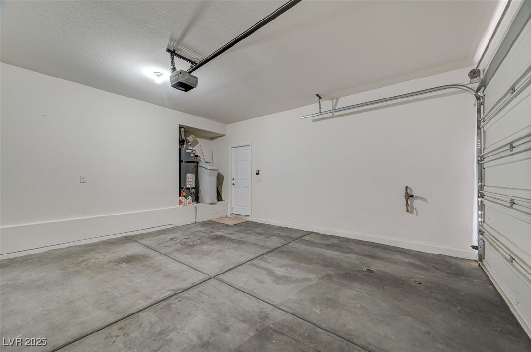 5377 Panaca Spring Street Las Vegas, NV 89122 - Photo 45 of 59 Garage featuring a garage door opener and secured water heater