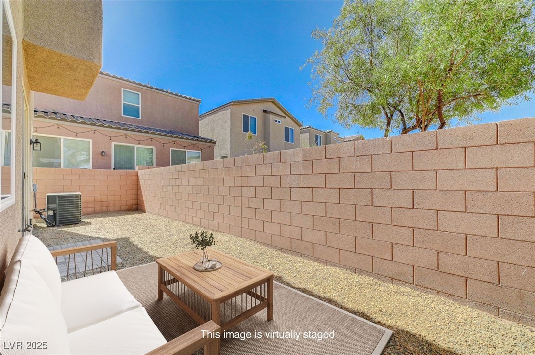 5377 Panaca Spring Street Las Vegas, NV 89122 - Photo 46 of 59 Fenced backyard with a patio and a residential view