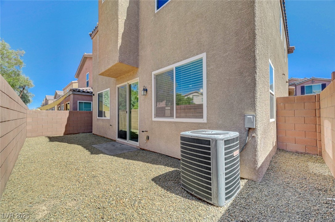 5377 Panaca Spring Street Las Vegas, NV 89122 - Photo 50 of 59 Rear view of property with stucco siding and a fenced backyard