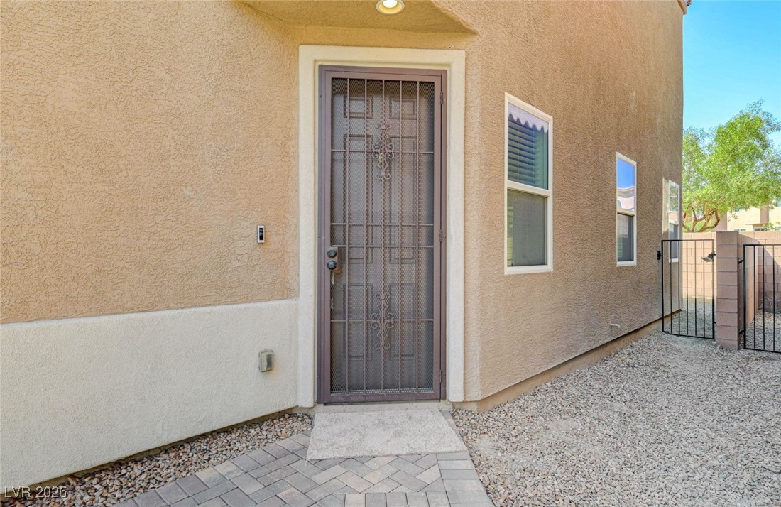5377 Panaca Spring Street Las Vegas, NV 89122 - Photo 7 of 59 Entrance to property with a gate and stucco siding