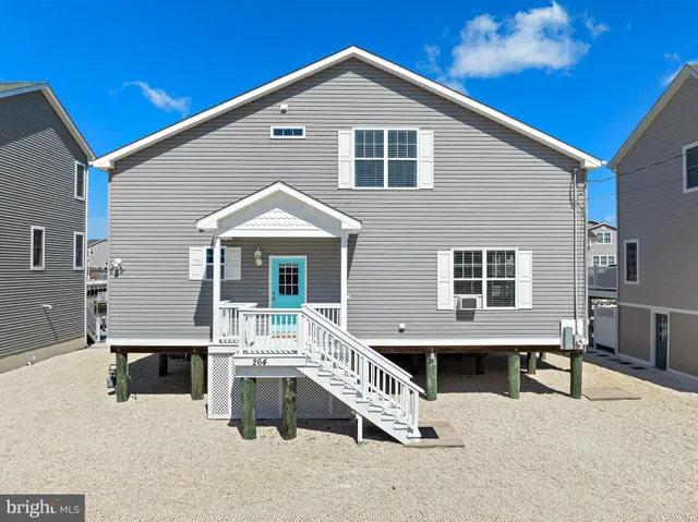 a kitchen with cabinets stainless steel appliances and wooden floor