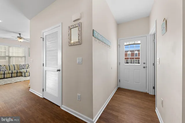 a kitchen with stainless steel appliances granite countertop wooden floors and white cabinets
