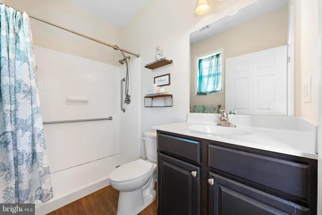 a view of a roof deck with table and chairs a barbeque with wooden floor and fence