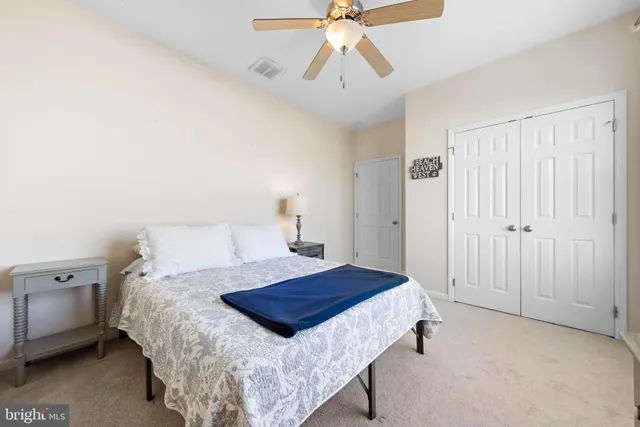 a view of a swimming pool with a lawn chairs and potted plants