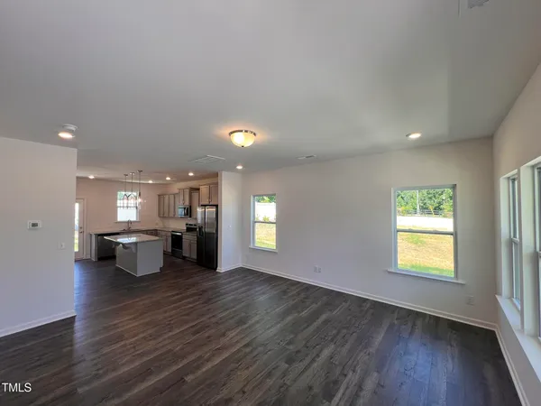 an open kitchen with a table and chairs in it